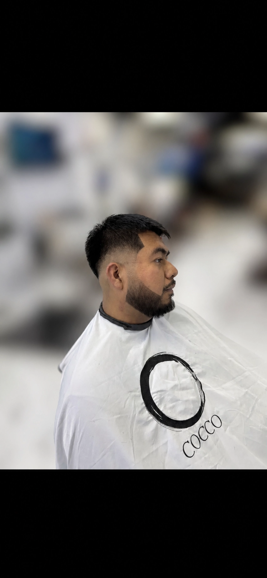 Clean mid fade with textured top and full beard shape-up by Almighty Cutz By Jesus.